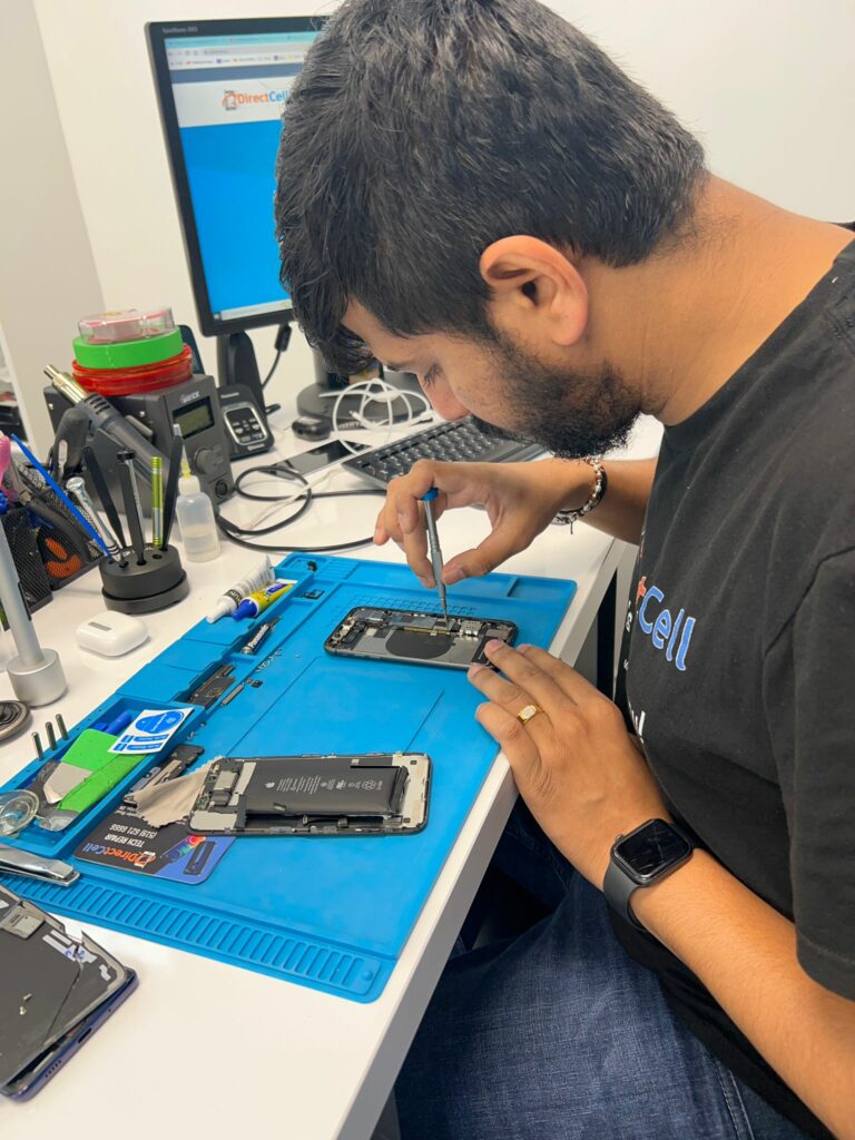 Direct Cell Technician repairing iPhone